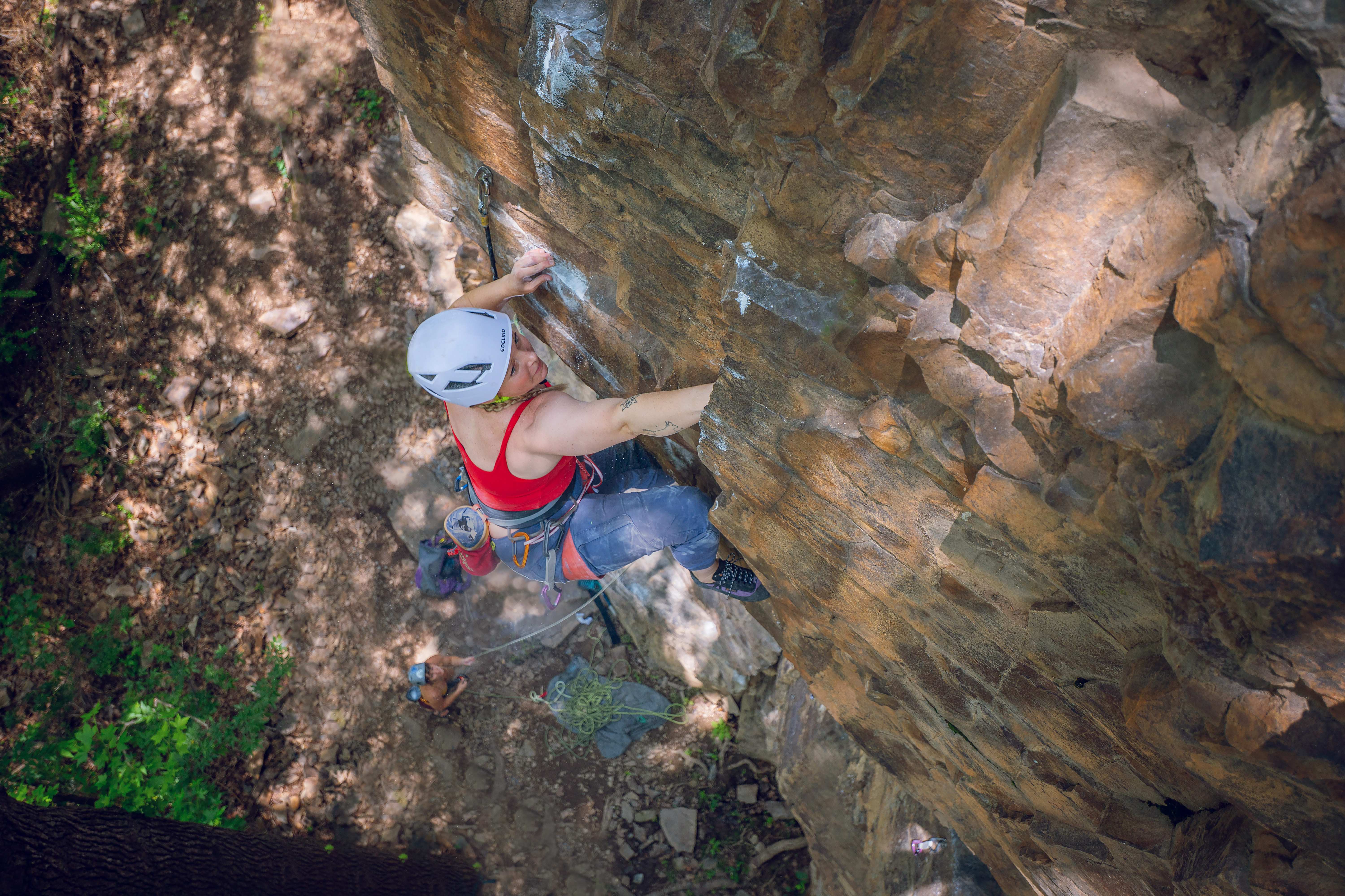 Woman rock climbing at Crystal Bluff climbing area in North Little Rock, Arkansas